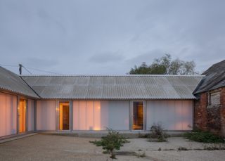 The barn's translucent walls glow from within once it gets dark