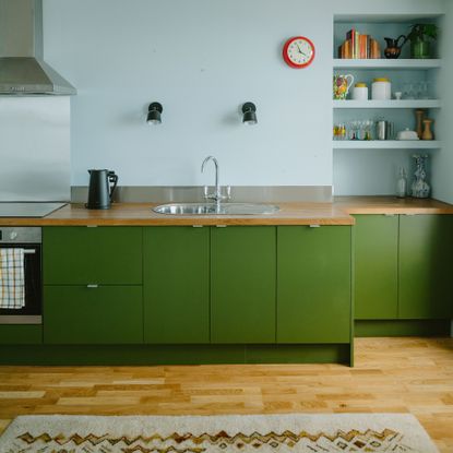 Green modern kitchen with blue walls