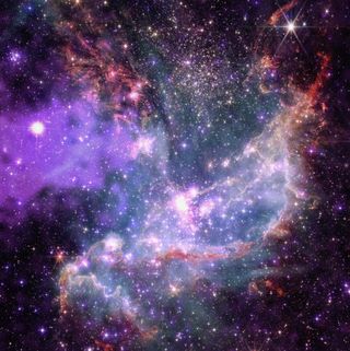 a dense cloud of stars and colorful gases in deep space