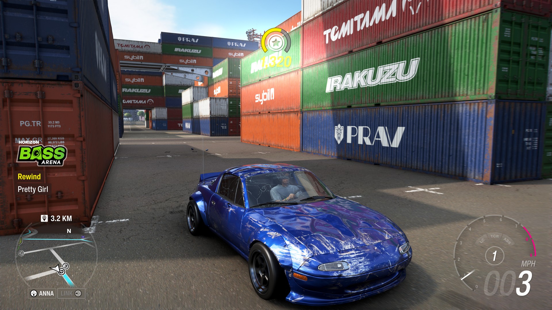 A smashed up car idles among cargo containers in Forza Horizon 6