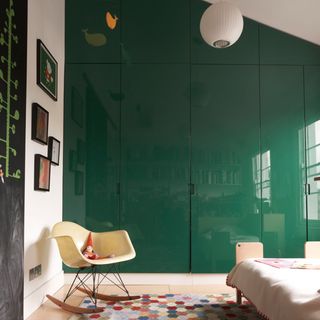 bedroom with white walls and green cabinet