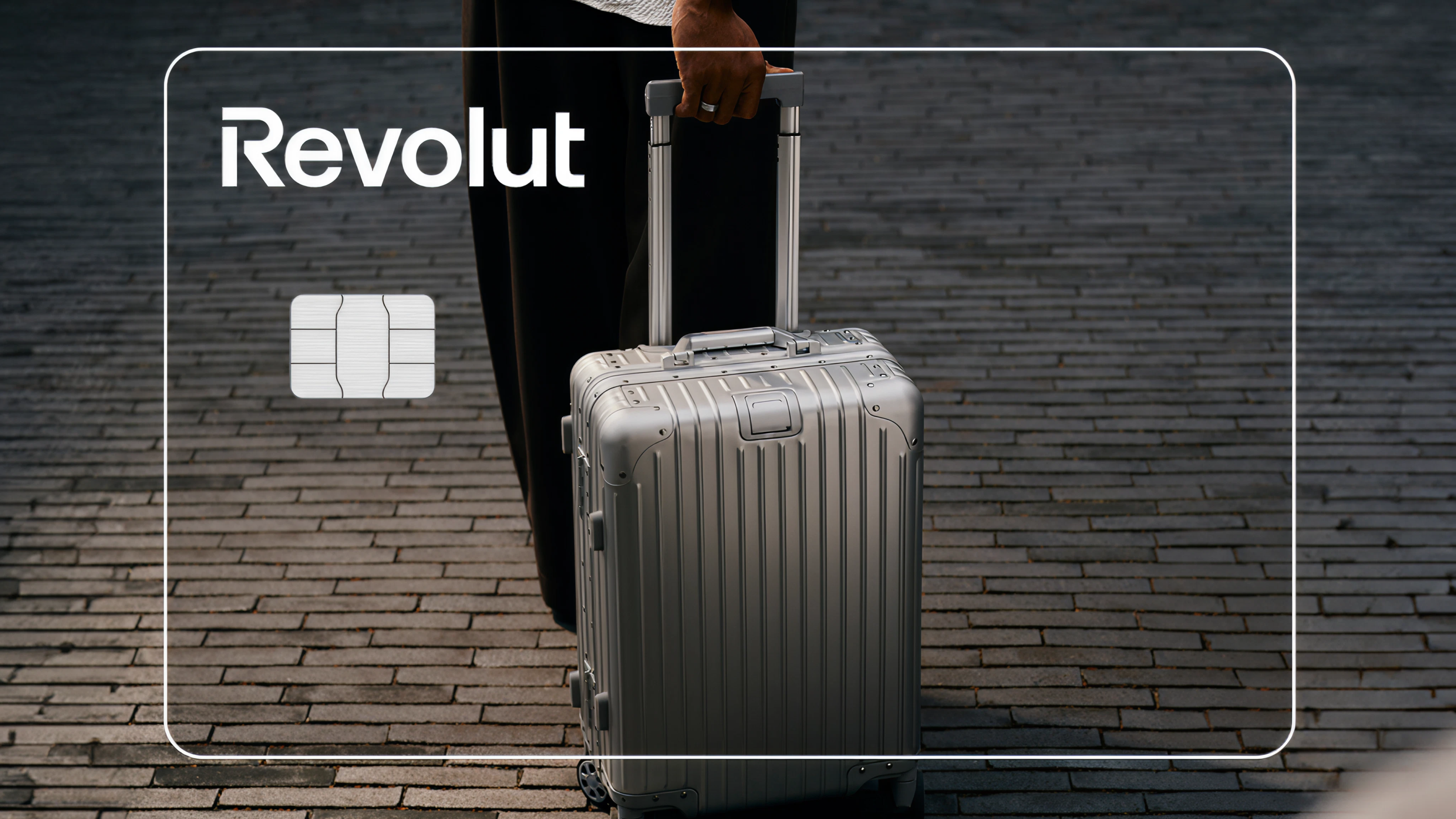 A suitcase overlaid with the image of a Revolut card.
