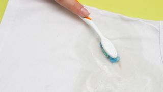 Removing stain with toothbrush