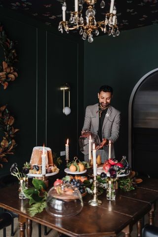 a person decorating a dining table for christmas