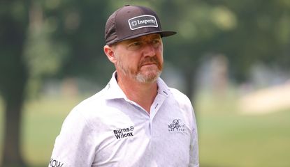 Jimmy Walker walks on whilst staring into the distance