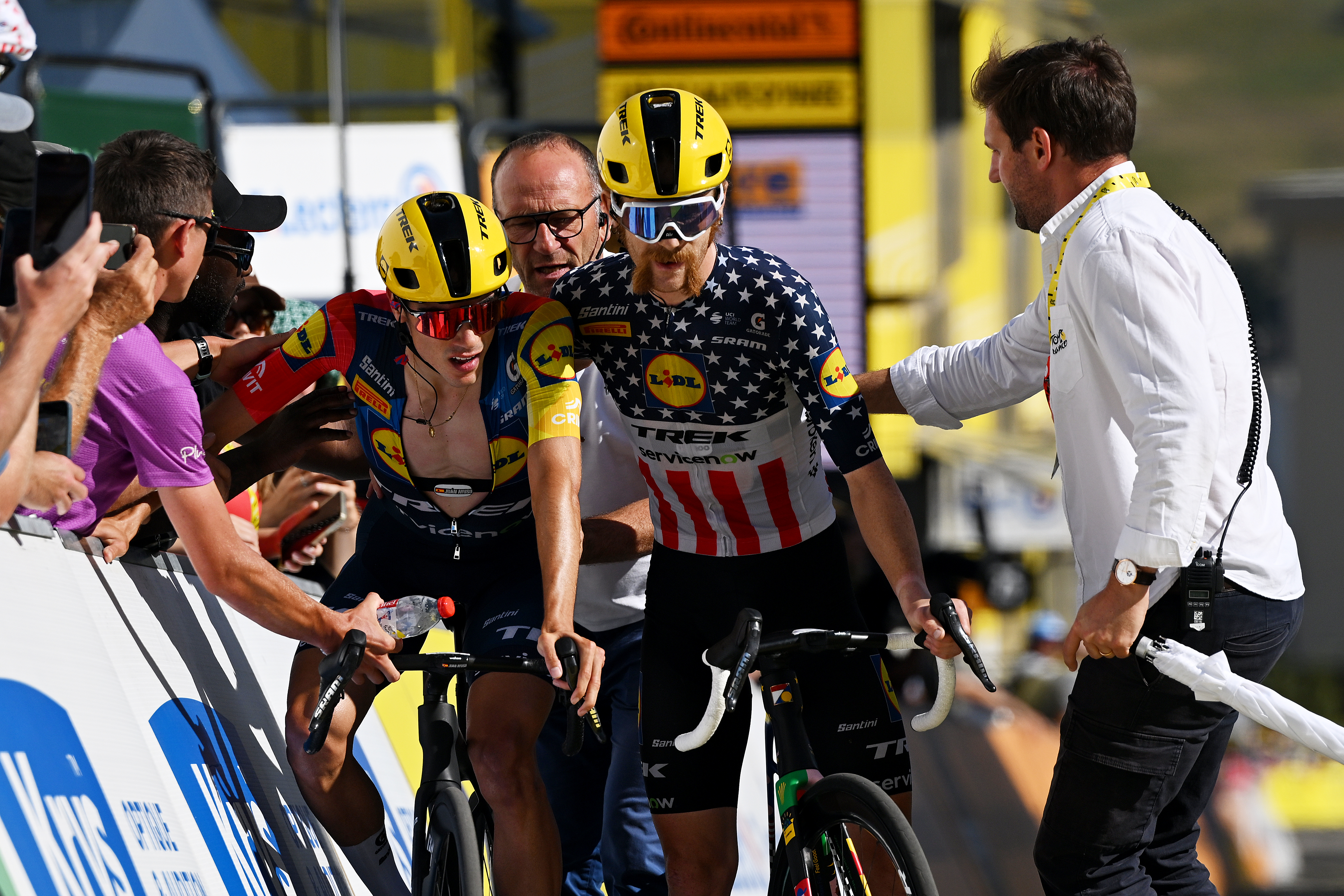 Quinn Simmons helps Lidl-Trek teammate Juan Ayuso cross the finish of stage 19 atop Alpe d'Huez 