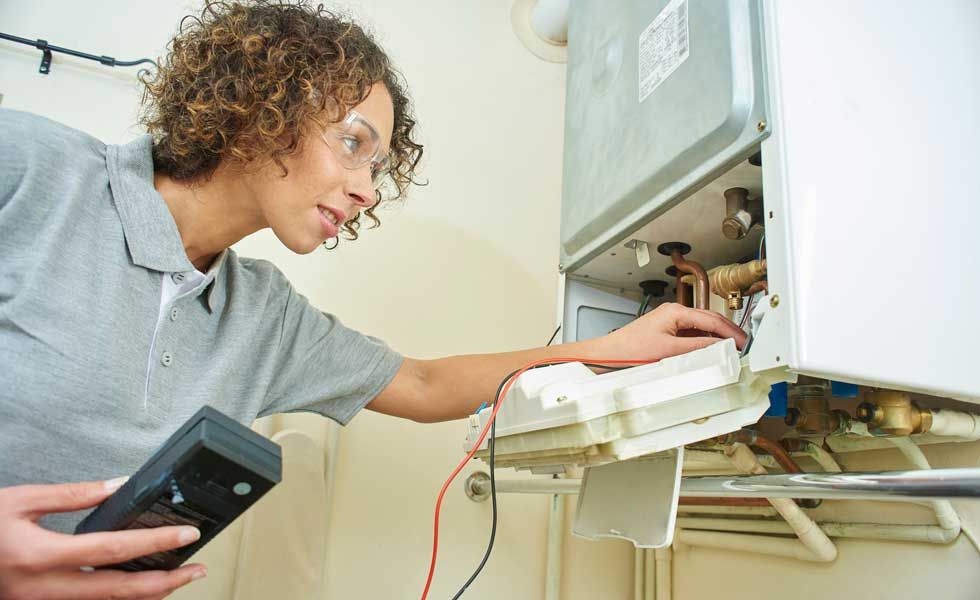 woman servicing a boiler