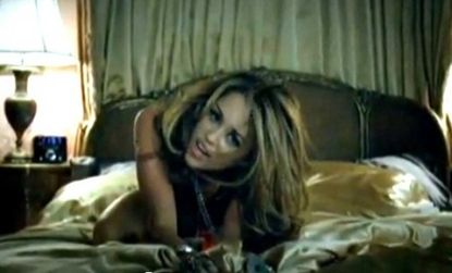 Miley's newest music video shows her sprawled out on a bed, and later dancing in a nightclub with older men. 