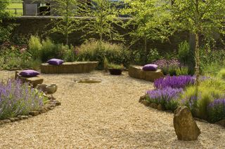 Gravel garden with rock seats and wild flowers