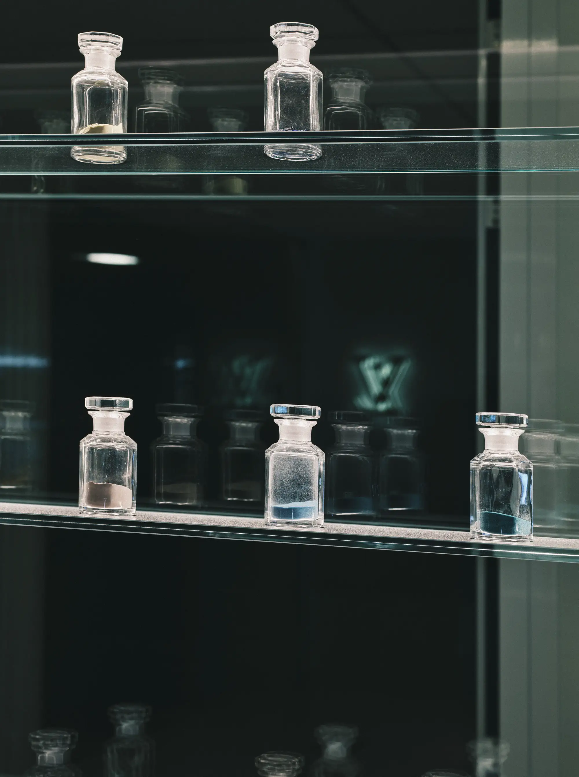 Small apothecary jars full of different powders used for enamelling the Louis Vuitton watches.