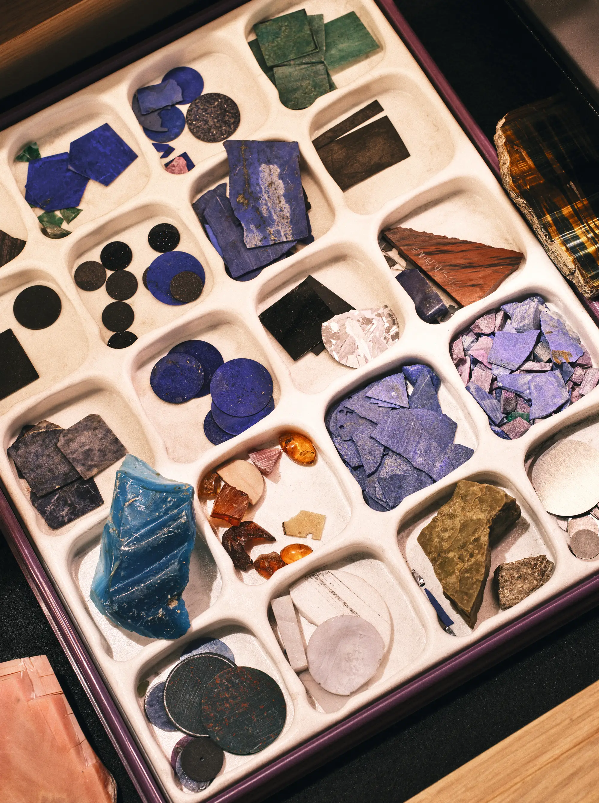A box holding multiple varieties of hardstone, which are ground up to use as enamel in the watches.