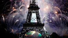 Fireworks light up the Olympic Rings attached to a sparkling Eiffel Tower