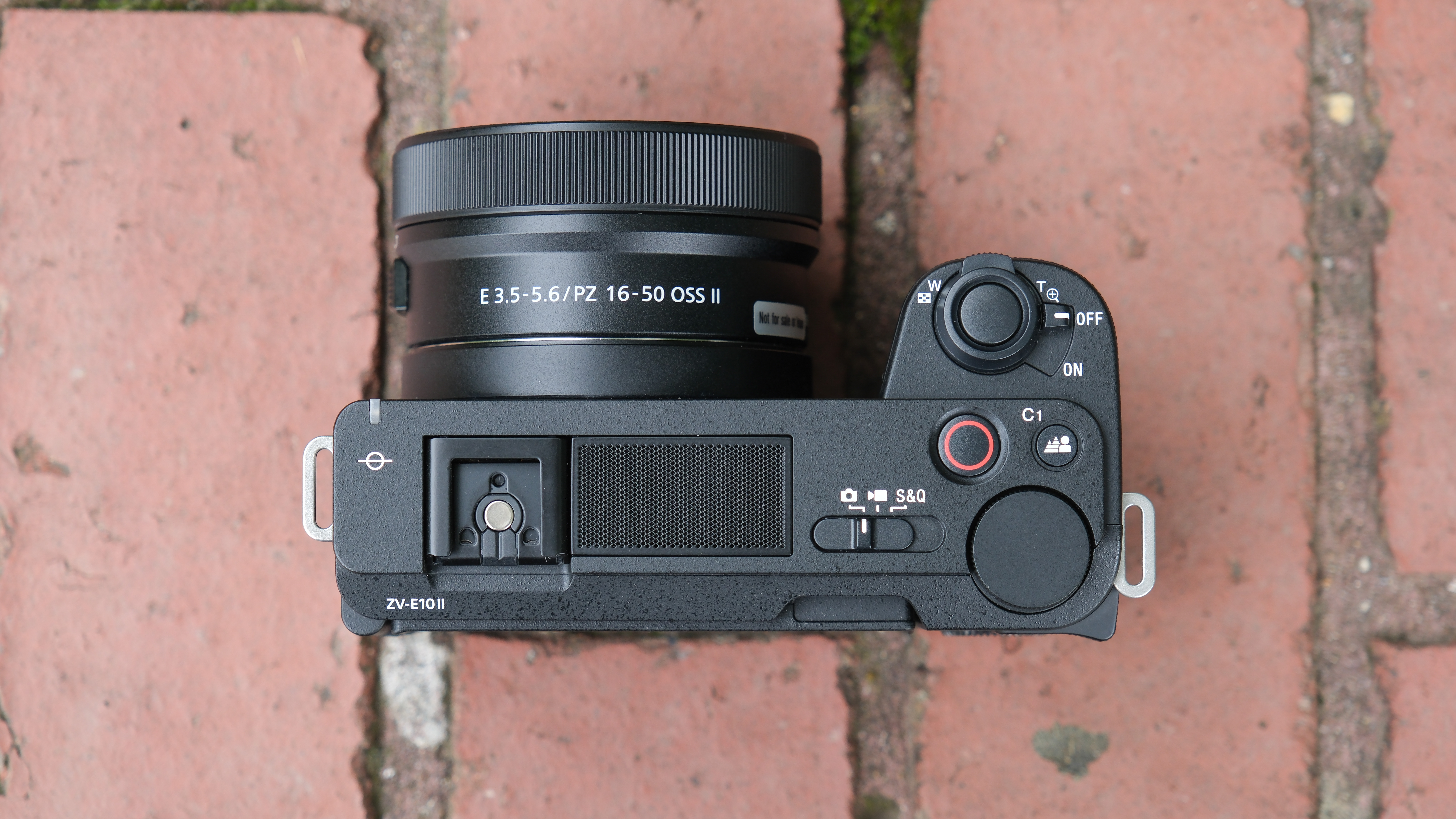 Sony ZV-E10 II digital camera sitting on a brick wall