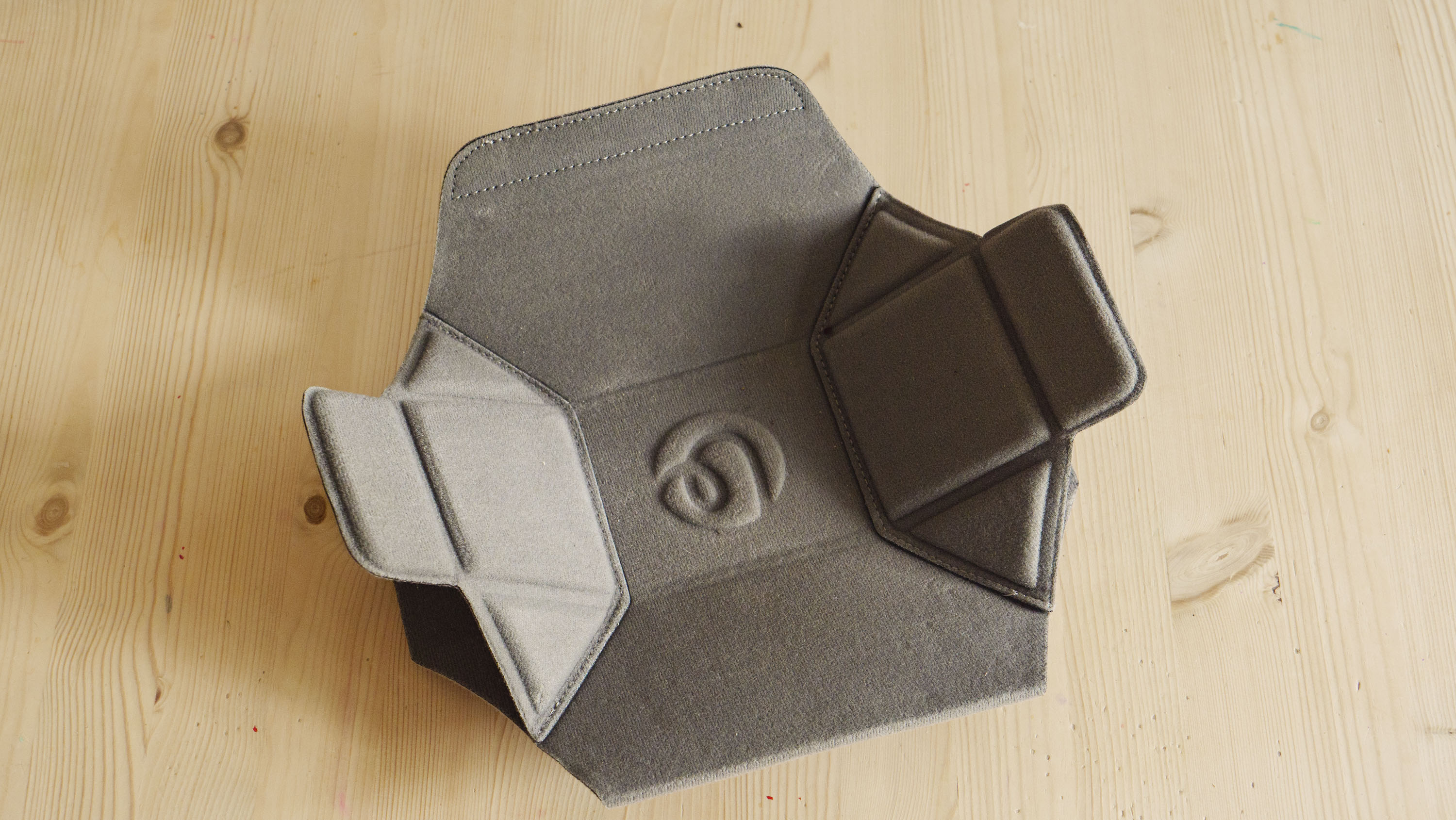 The Ulanzi Camera Sling Bag's padded insert on a wooden table