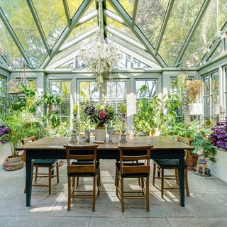 conservatory with chandelier and dinning table with chairs