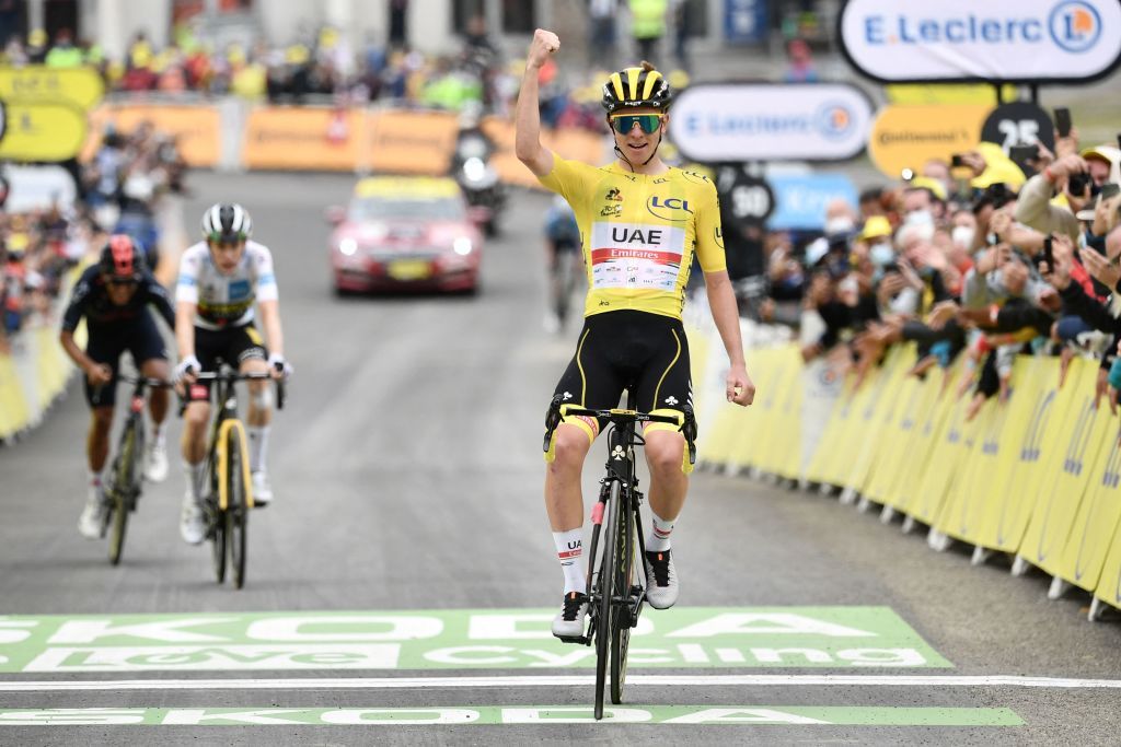 TOPSHOT Team UAE Emirates Tadej Pogacar of Slovenia wearing the overall leaders yellow jersey celebrates as he crosses the finish line during the 18th stage of the 108th edition of the Tour de France cycling race 129 km between Pau and Luz Ardiden on July 15 2021 Photo by Philippe LOPEZ AFP Photo by PHILIPPE LOPEZAFP via Getty Images