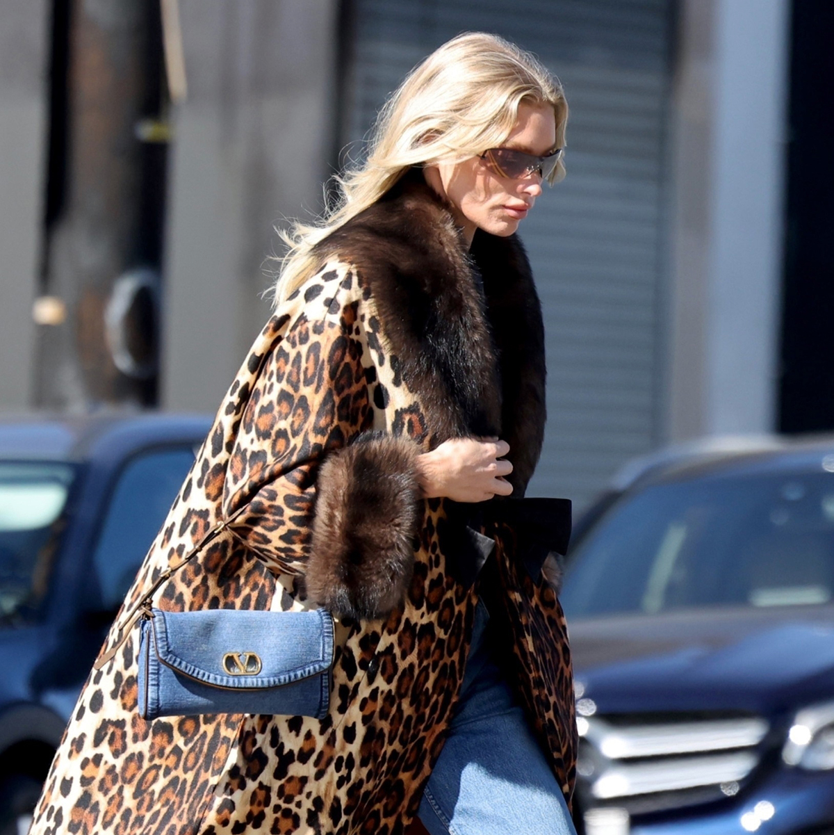 Elsa Hosk wearing a leopard coat, denim Valentino bag, jeans, and cognac pumps