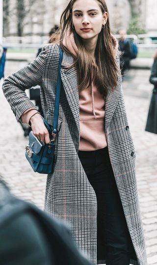 woman-wearing-hoodie-with-coat-at-london-fashion-week-2106605-1488584503