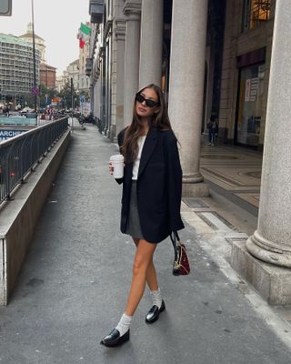 woman in a blazer and a skirt