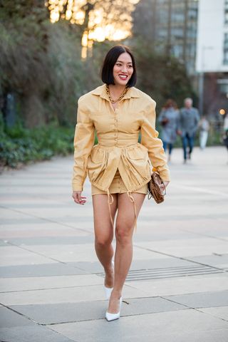 Woman wearing a long-sleeve minidress and heels.