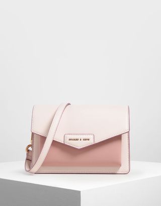 Charles 
Keith + Light Pink Zaina Envelope Crossbody Bag