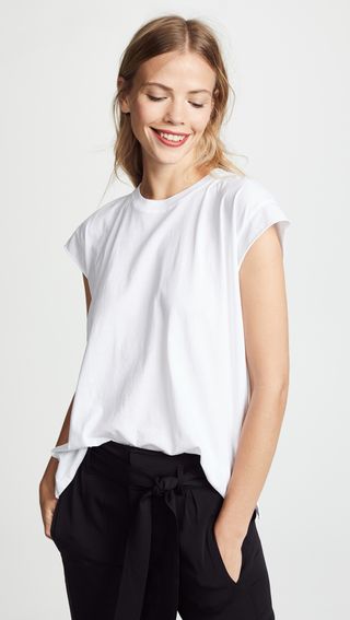 a model wears a white crewneck T-shirt with black jeans