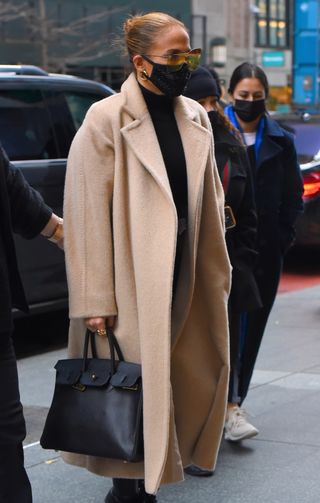 Hermès Birkin Bag Prices: How Much and Are They Worth It: jennifer lopez with a black Hermès Birkin bag