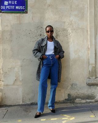 woman's outfits with bootcut jeans, white t-shirt, and herringbone print coat