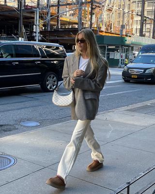 woman's outfit with white bootcut jeans and t-shirt and blazer