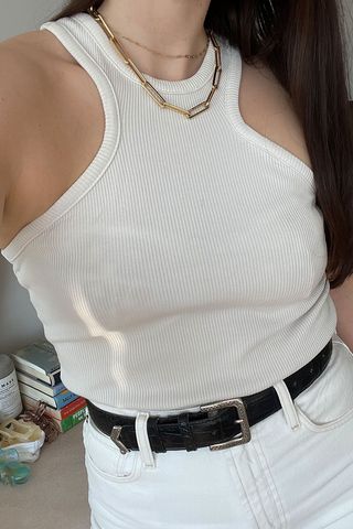 close-up shot of Anna LaPlaca wearing white tank top and white jeans