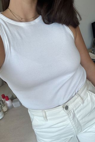 Anna LaPlaca wearing white tank top and white jeans