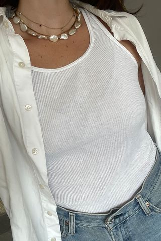 close-up shot of Anna LaPlaca wearing white tank top and white button-down shirt