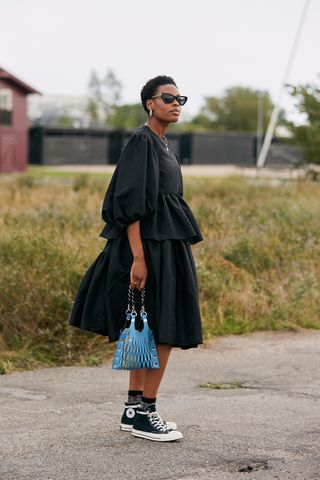 Donna pairs her puffball dress with Converse and a mini bag.