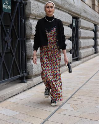 Mira wears her converse with a roll-neck layered underneath a floral-print maxi dress.