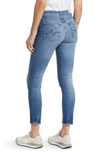 Waist-down shot of woman wearing AG Prima Ankle Cigarette Jeans with back turned to camera