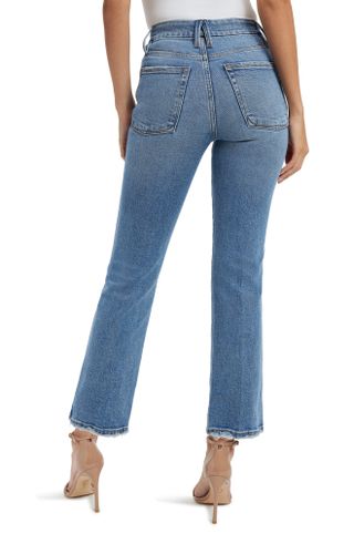 Woman wearing Good American Good Curve High Waist Straight Leg Jeans with back to camera