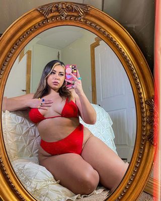 a photo of a woman wearing a red swimsuits for curves