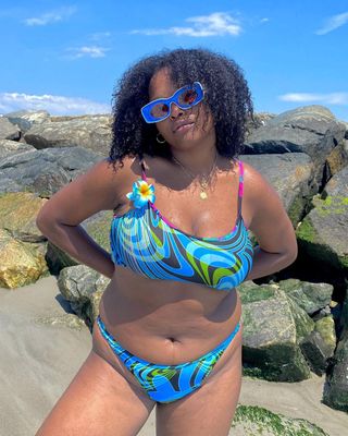 a photo of a curvy woman wearing a printed swimsuit