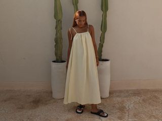 best sandals for women, a photo of a woman wearing sandals and yellow dress