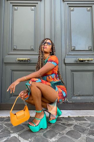 woman wearing platform wedge sandals with colorful mesh dress