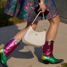 a close up photo of a woman wearing designer cowboy boots