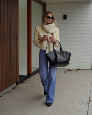 a photo of a woman wearing one of the best mid-range designer bags