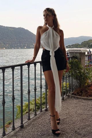 a woman's outfit with platform sandals, black shorts, and halter top