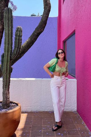 a woman's outfit with platform flip-flops, white jeans, and a green crop top
