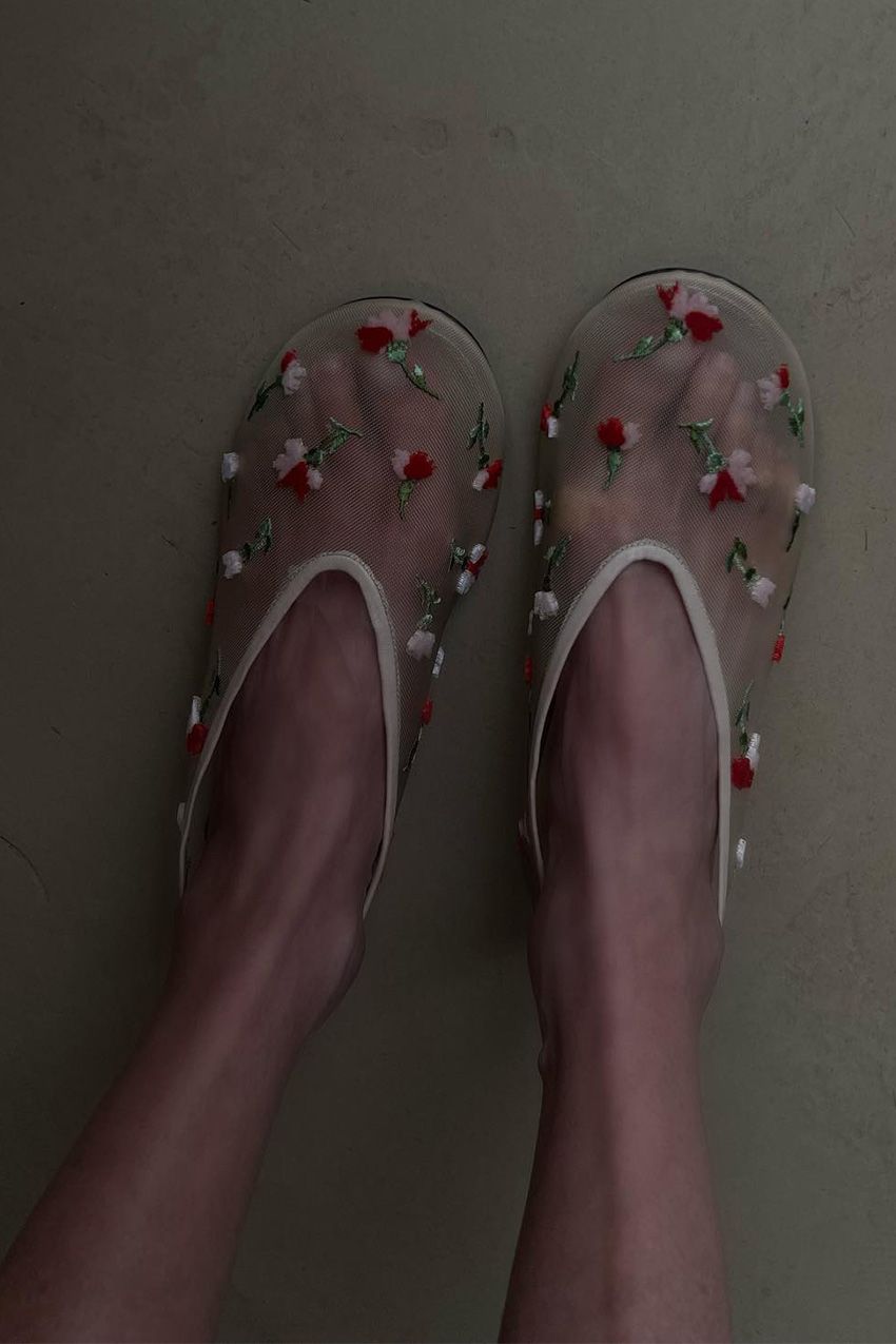 Chloé Harrouche Founder and Creative Director of louloudesaison wears the Khaite Beige Mesh with Pink Floral Embroidery.
