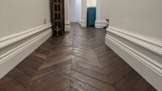 skirting board ideas with herringbone parquet wood flooring