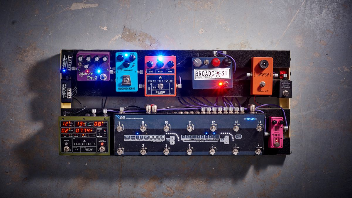 A fully-loaded pedalboard on a concrete floor