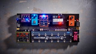A fully-loaded pedalboard on a concrete floor