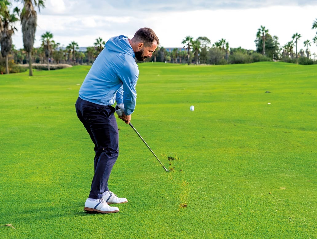 James Jankowski after impact with the ball flying off the clubface