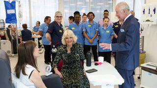 King Charles III and Queen Camilla meet with patient Jo Irons during a visit to the University College Hospital Macmillan Cancer Centre